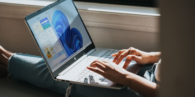 person using Windows 11 computer on lap