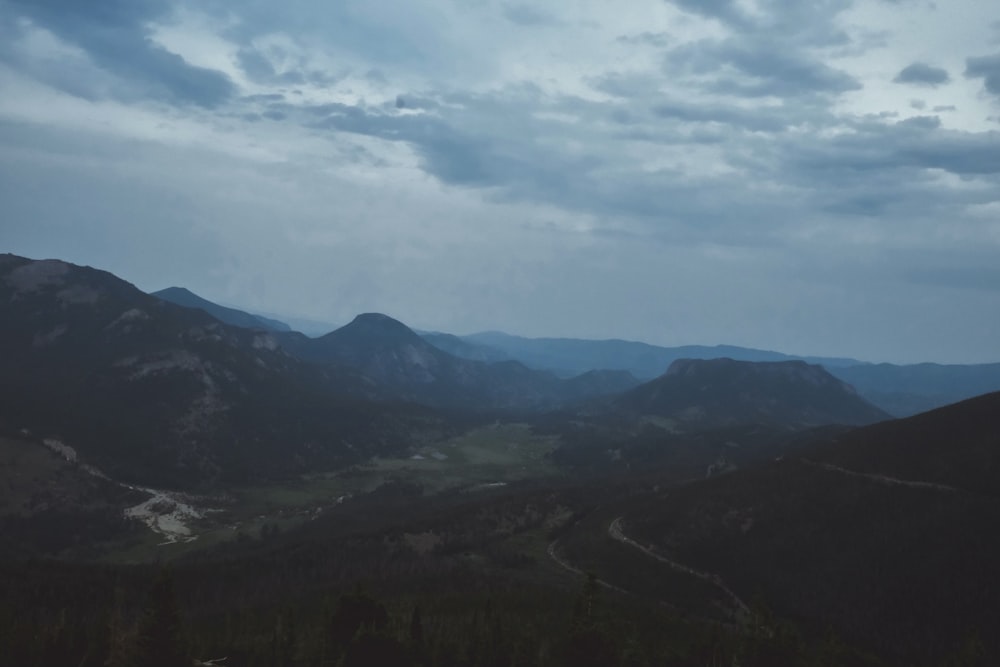 green mountains under white clouds during daytime