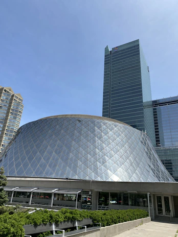 A panoramic shot of a contemporary building standing harmoniously within an urban setting.