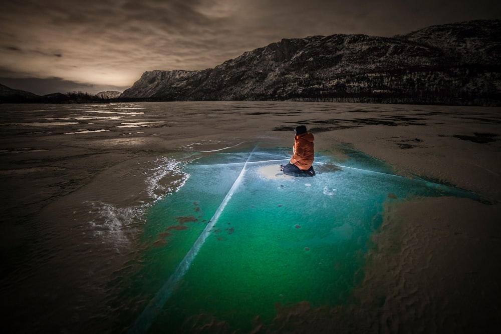 man in blue shorts on water