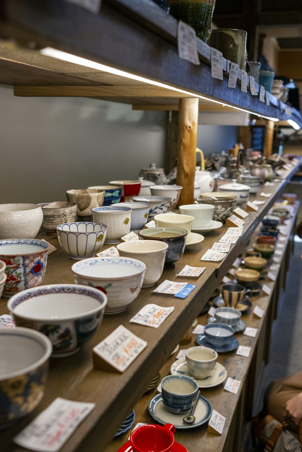 white ceramic bowls on brown wooden shelf