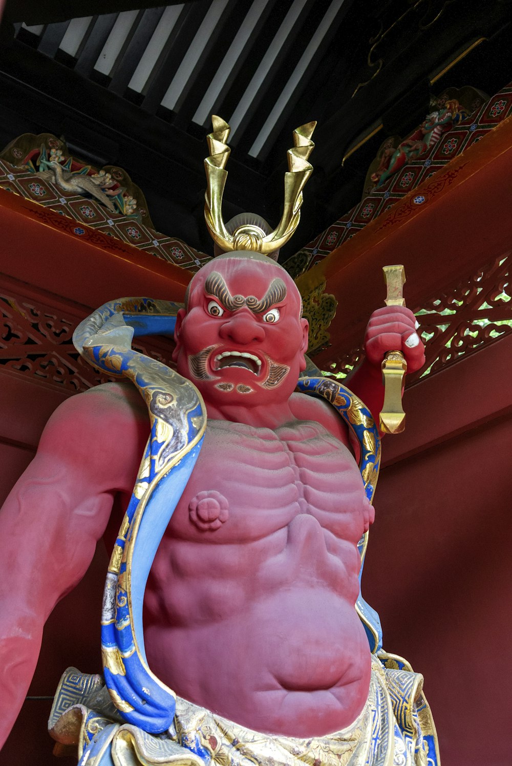 gold and red hindu deity figurine