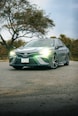 green mercedes benz coupe on road during daytime