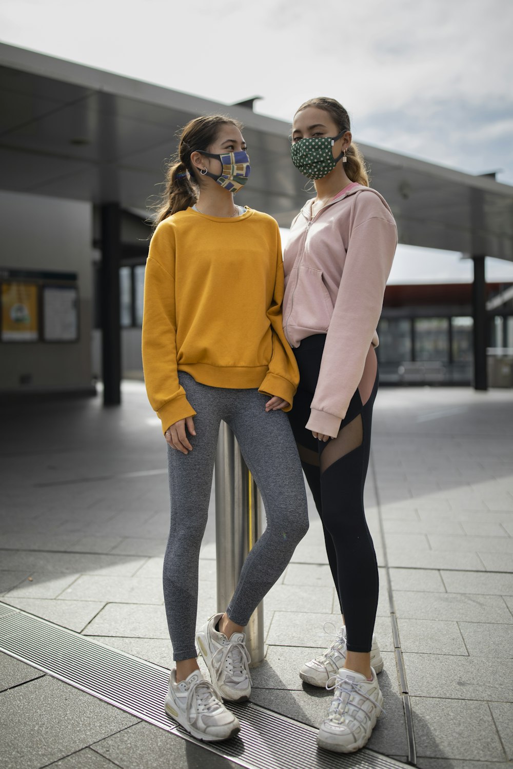 woman in orange long sleeve shirt and gray leggings wearing black framed eyeglasses