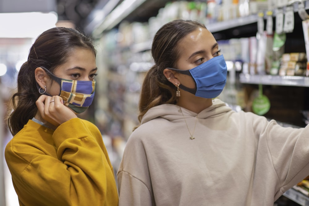 woman in white hoodie wearing blue goggles