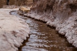 white rock formation on body of water during daytime