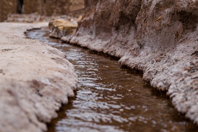 white rock formation on body of water during daytime