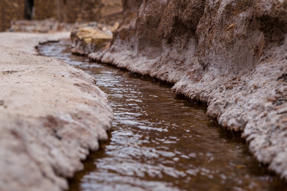 white rock formation on body of water during daytime