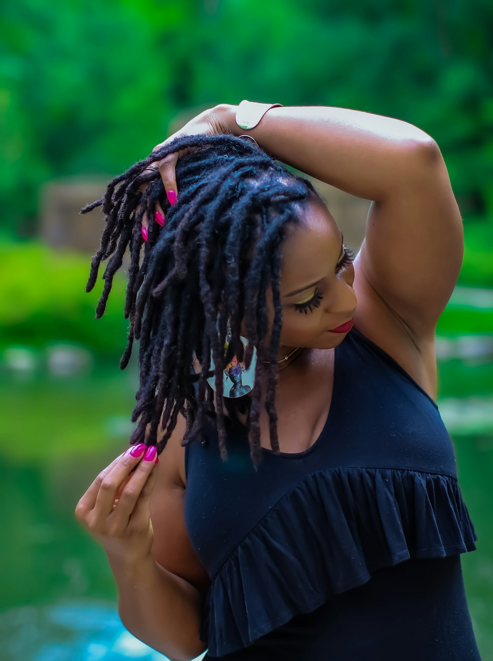 woman in black tank top holding her hair