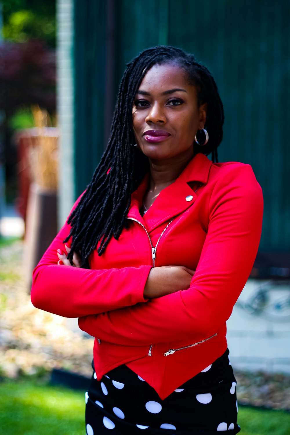 woman in red long sleeve shirt standing and smiling