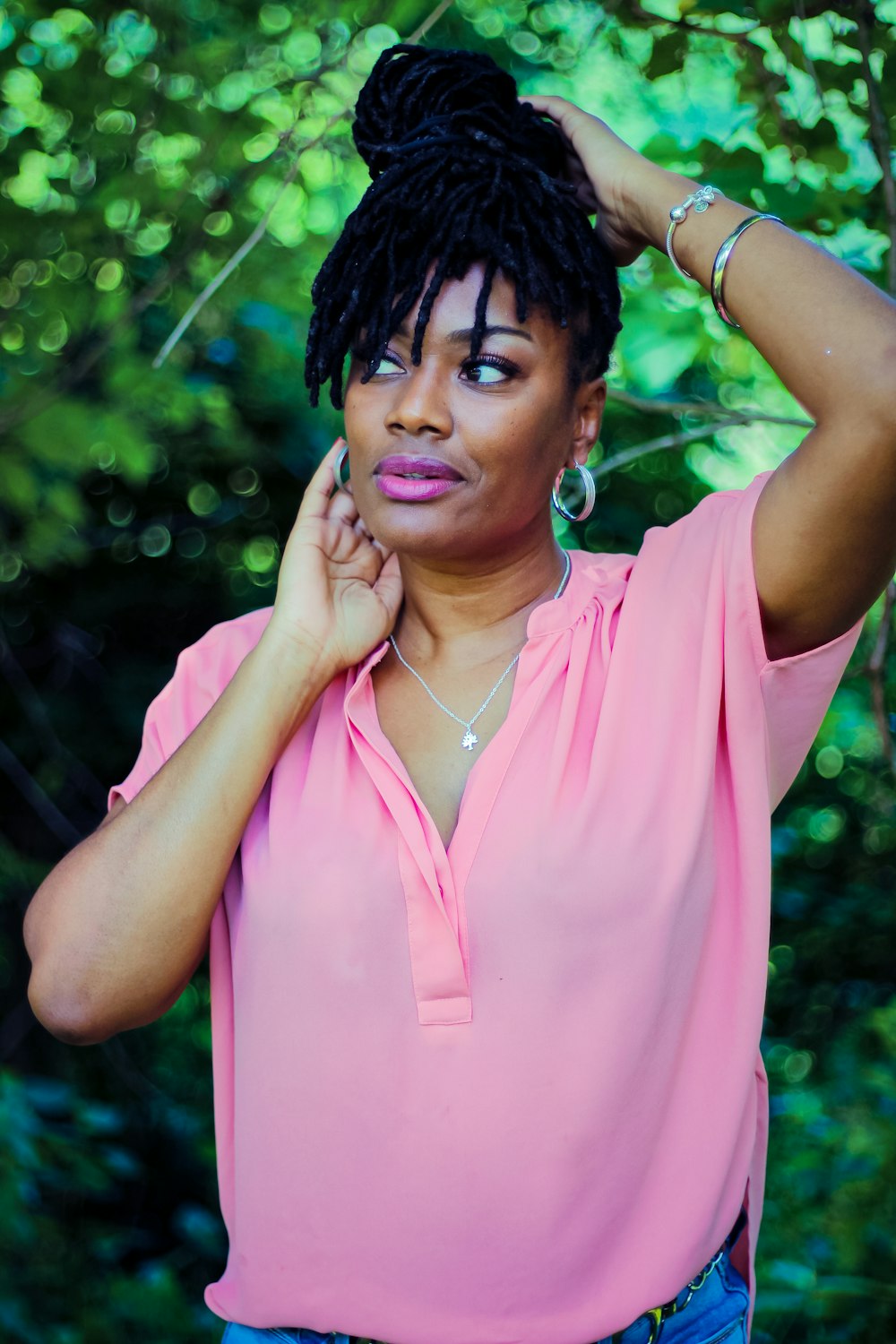 woman in pink sleeveless shirt with eyes closed