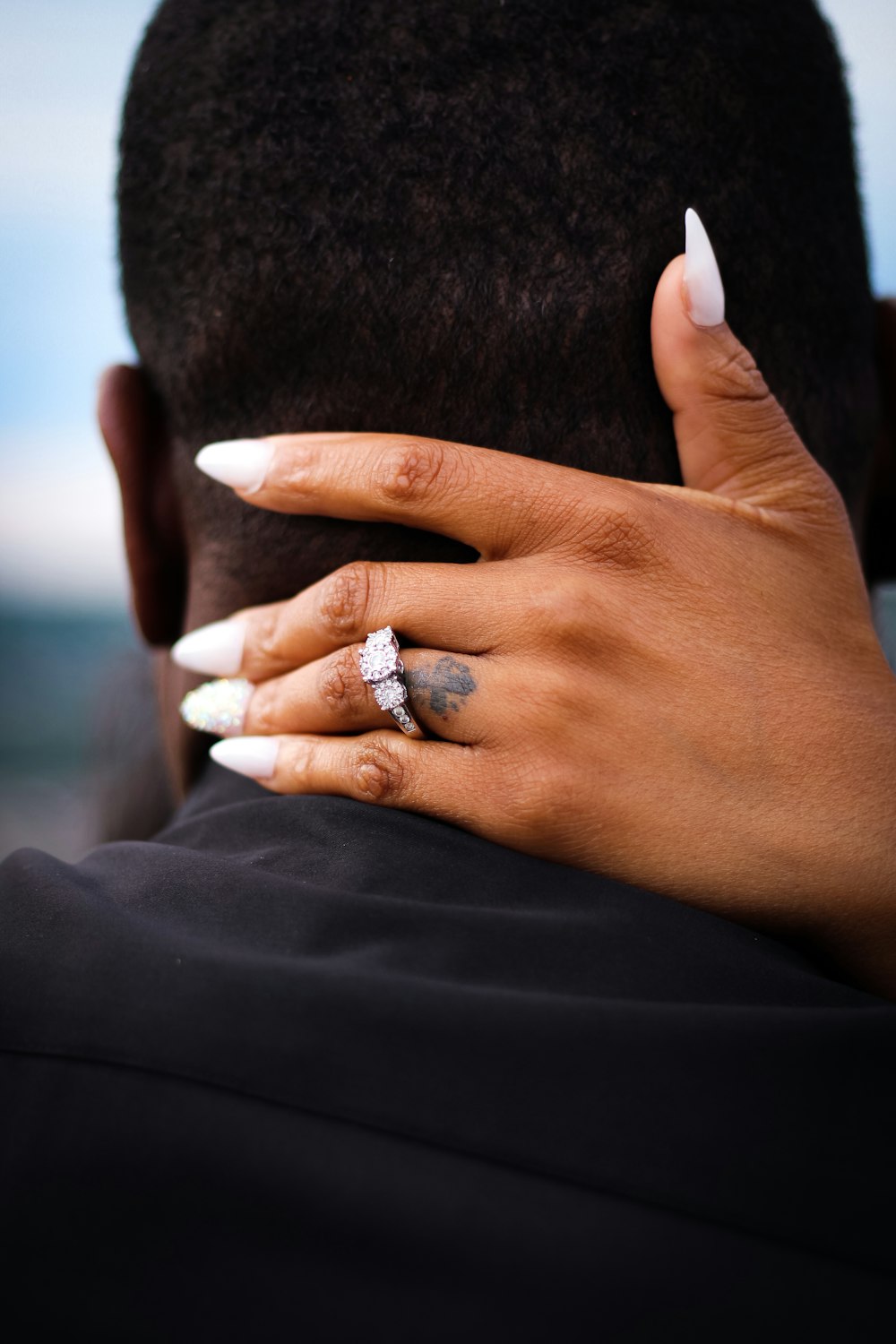 person wearing silver diamond ring