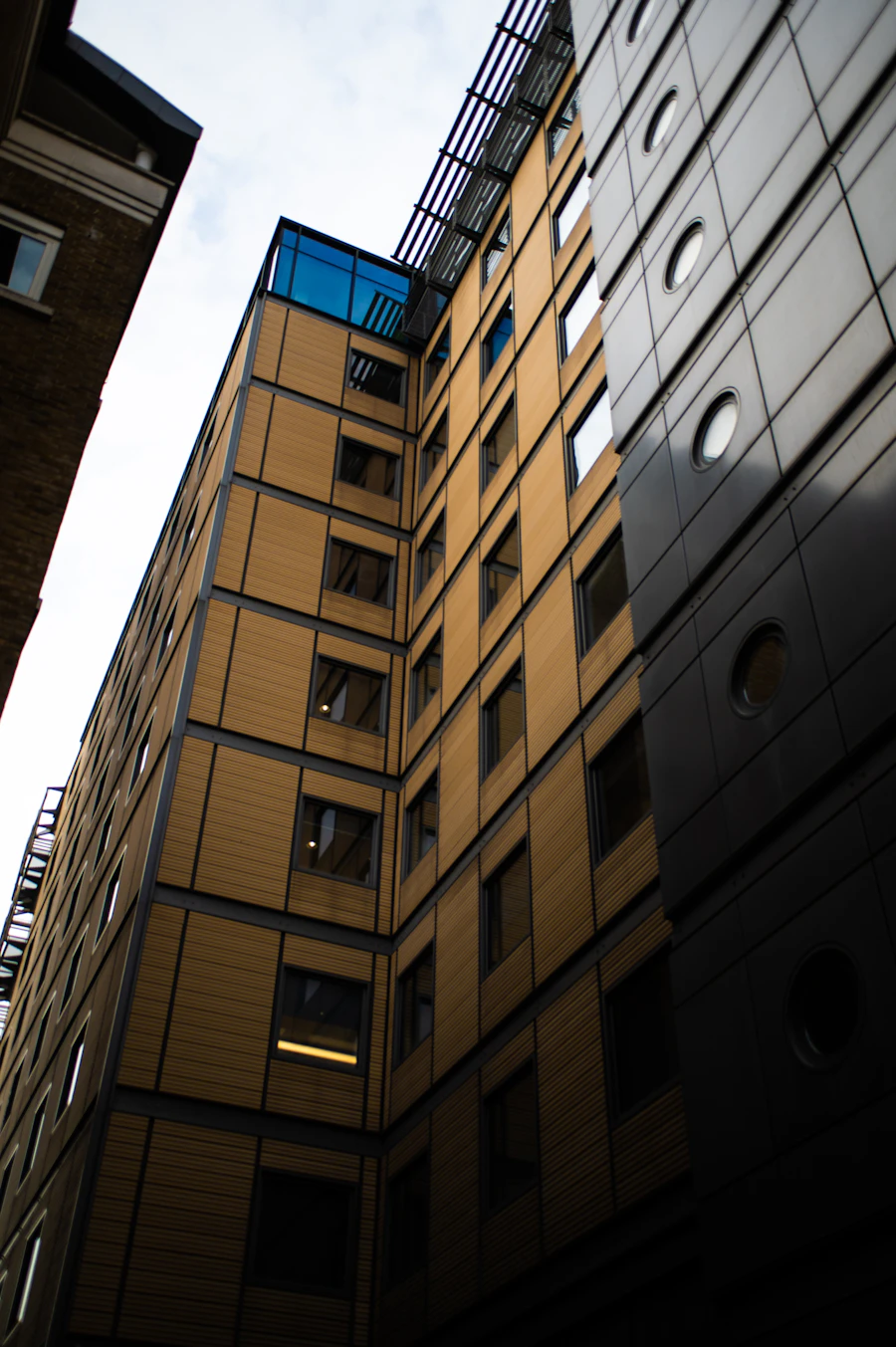 A modern apartment block clad in golden panels
