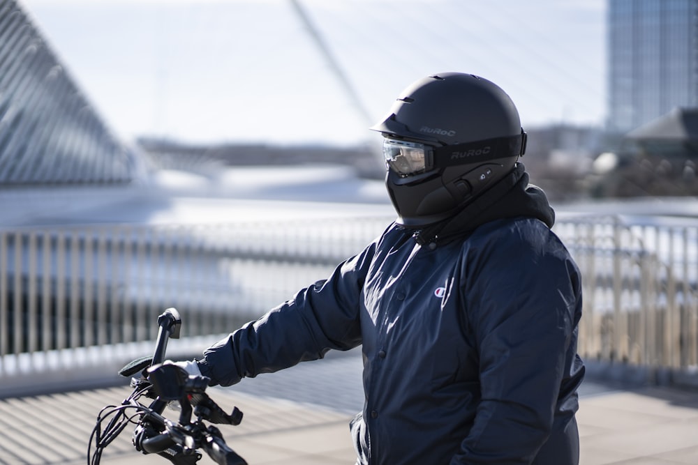 man in blue jacket riding motorcycle