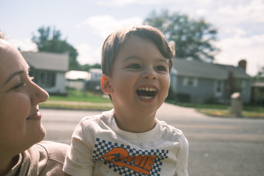 boy in white orange and black crew neck shirt