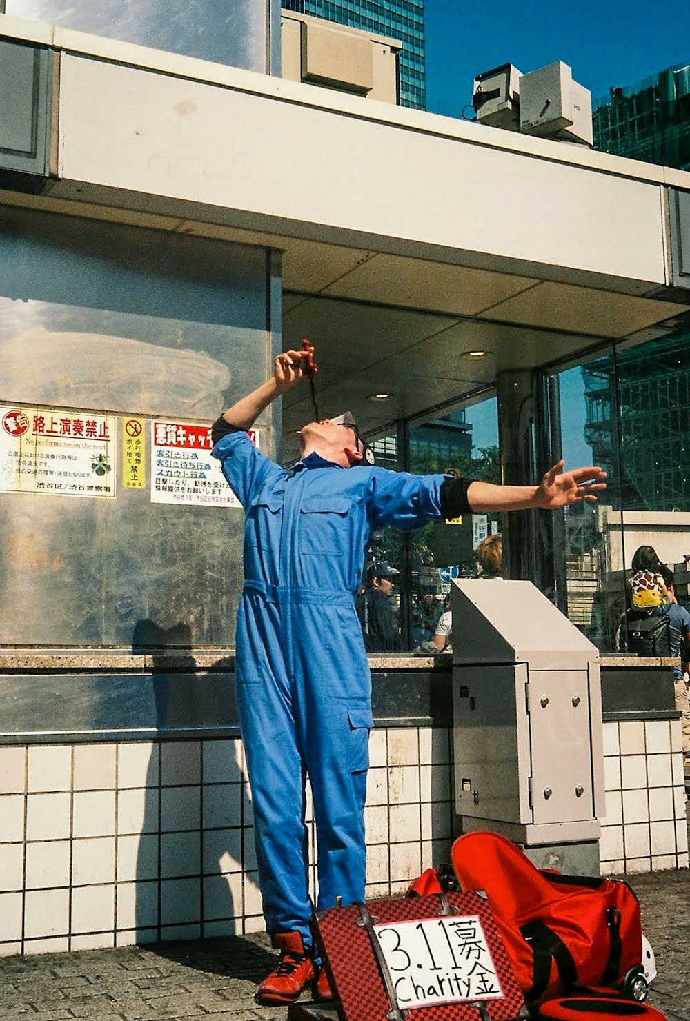 man in blue scrub suit standing near glass wall