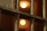 Metal bars in close-up with defocused warm lights in the background, suggesting a dimly lit environment.