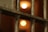Metal bars in close-up with defocused warm lights in the background, suggesting a dimly lit environment.