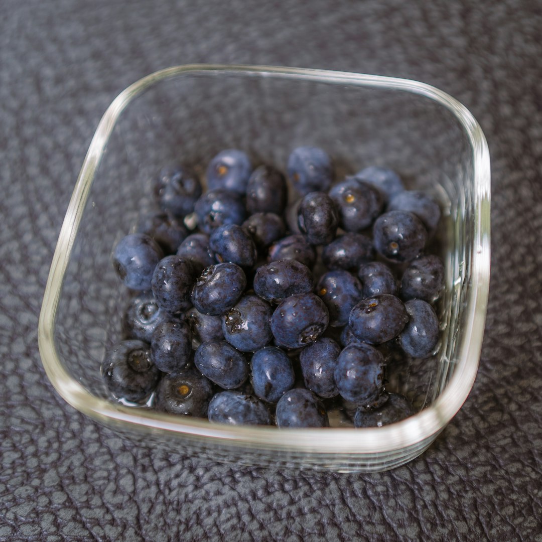 blue berries in clear glass bowl