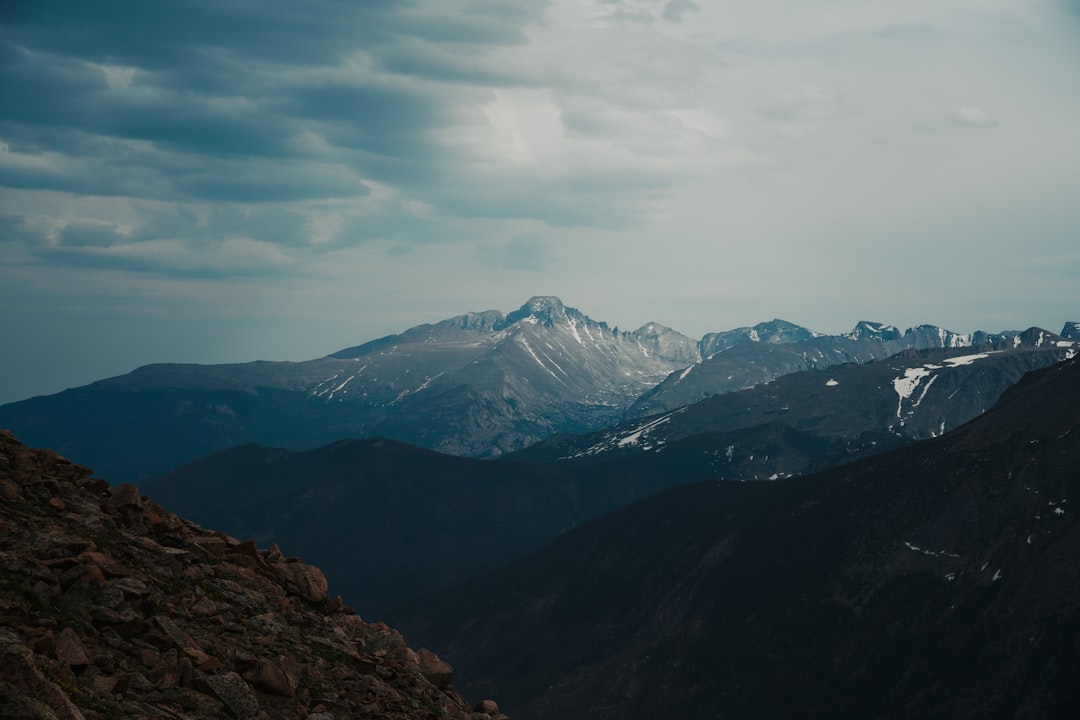 snow covered mountains under cloudy sky during daytime