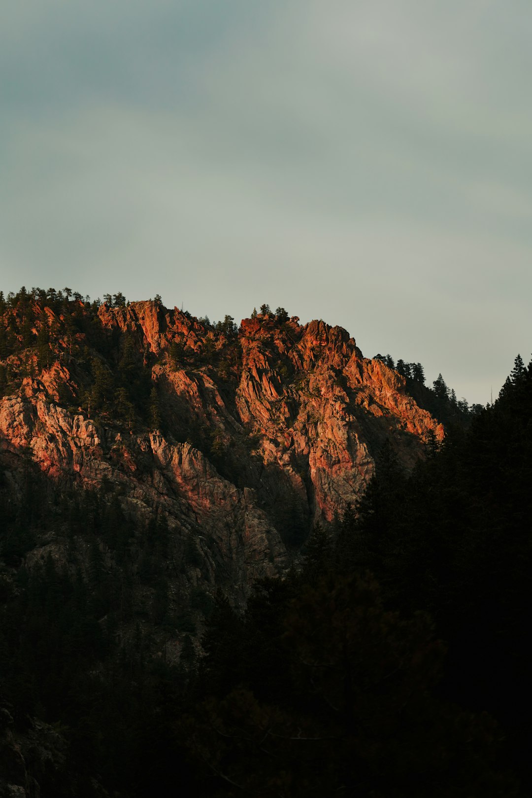 brown mountain under gray sky