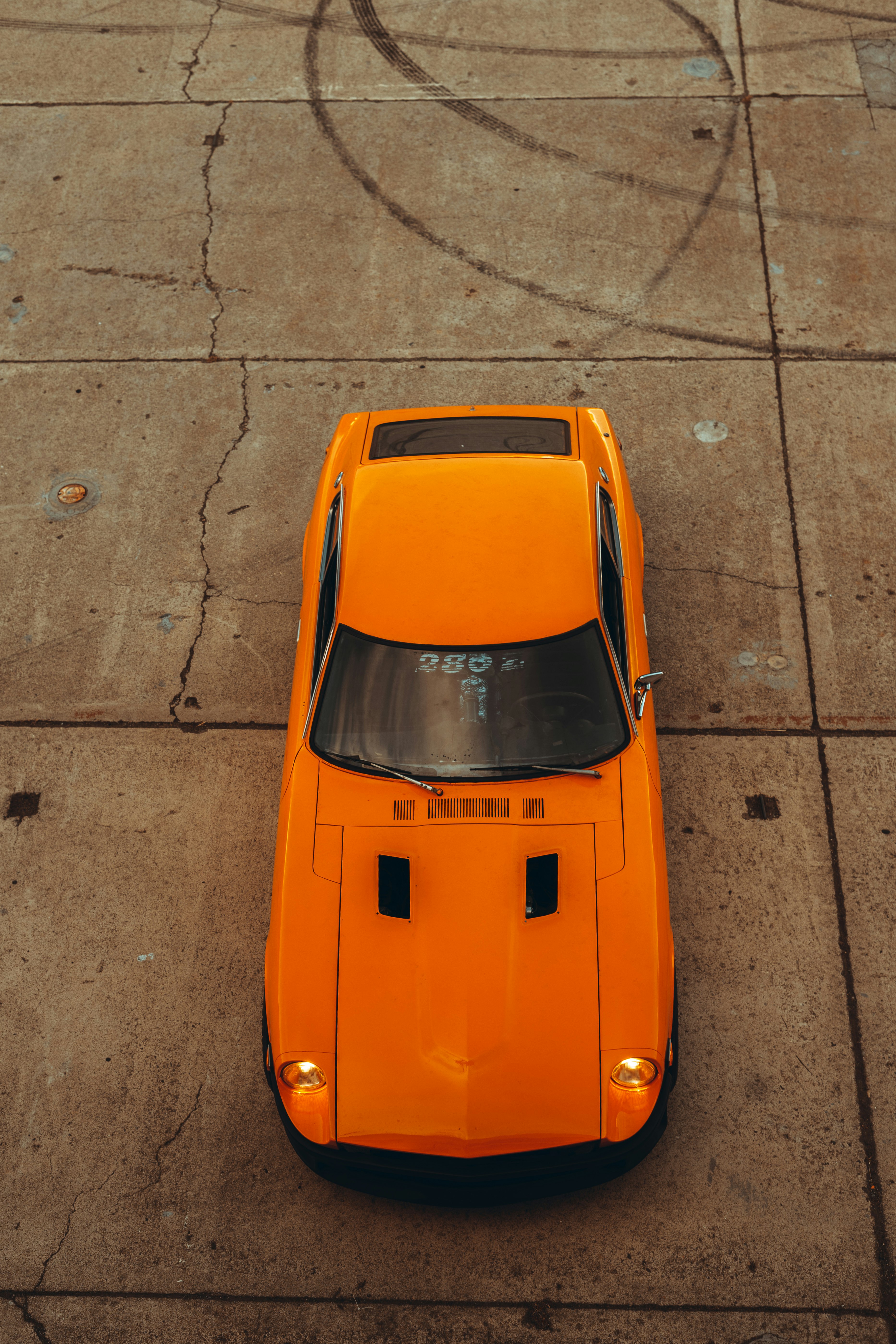 orange car on gray concrete road