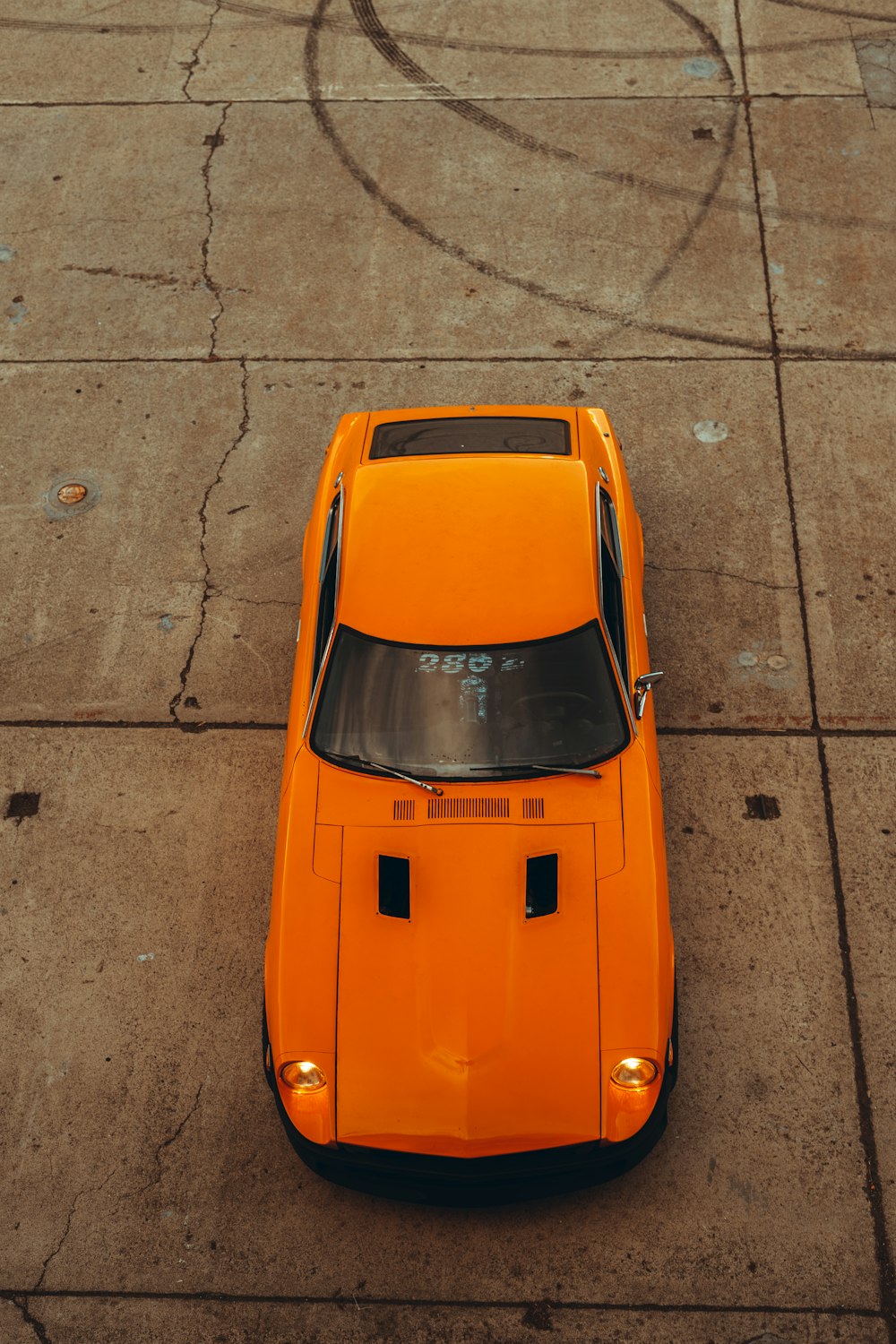 orange car on gray concrete road