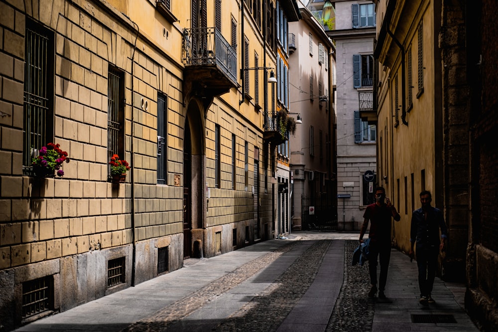 people walking on sidewalk near building during daytime