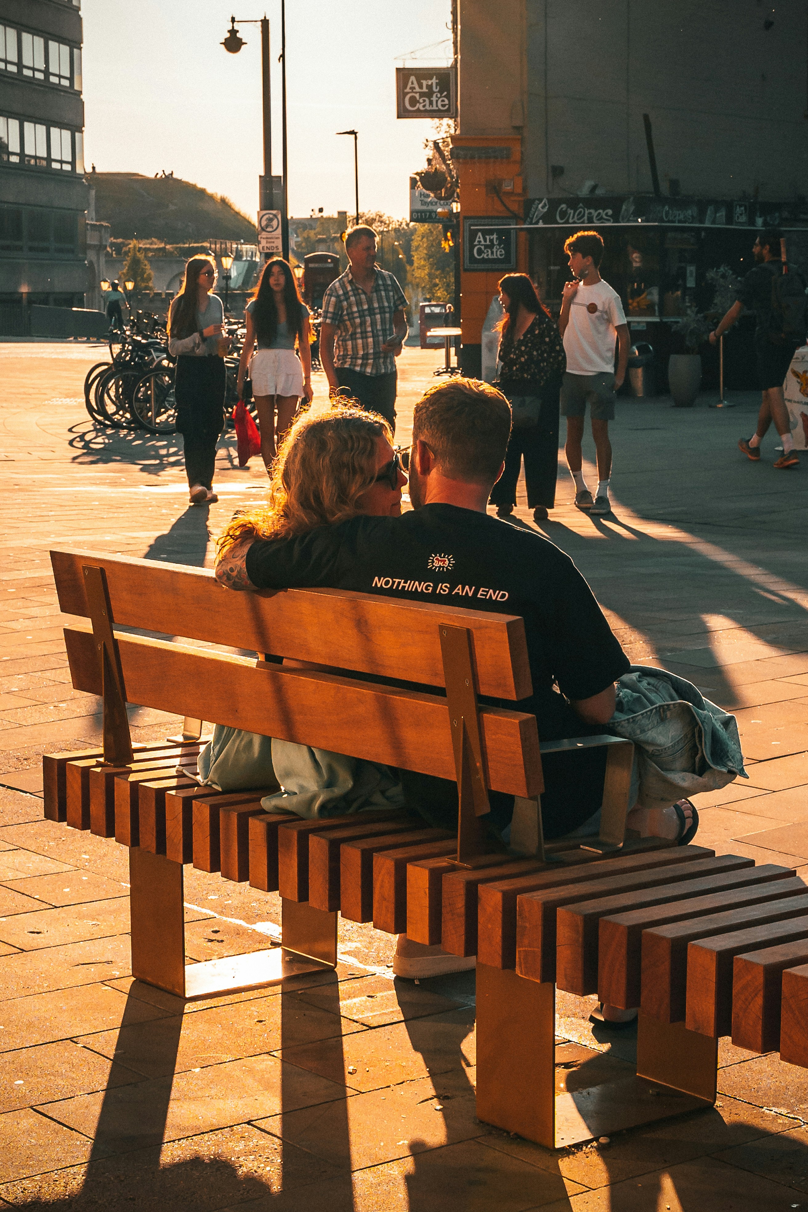 people sitting on brown wooden bench during daytime