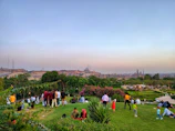 Scenic aerial view of a peaceful park with families enjoying sunny weather.