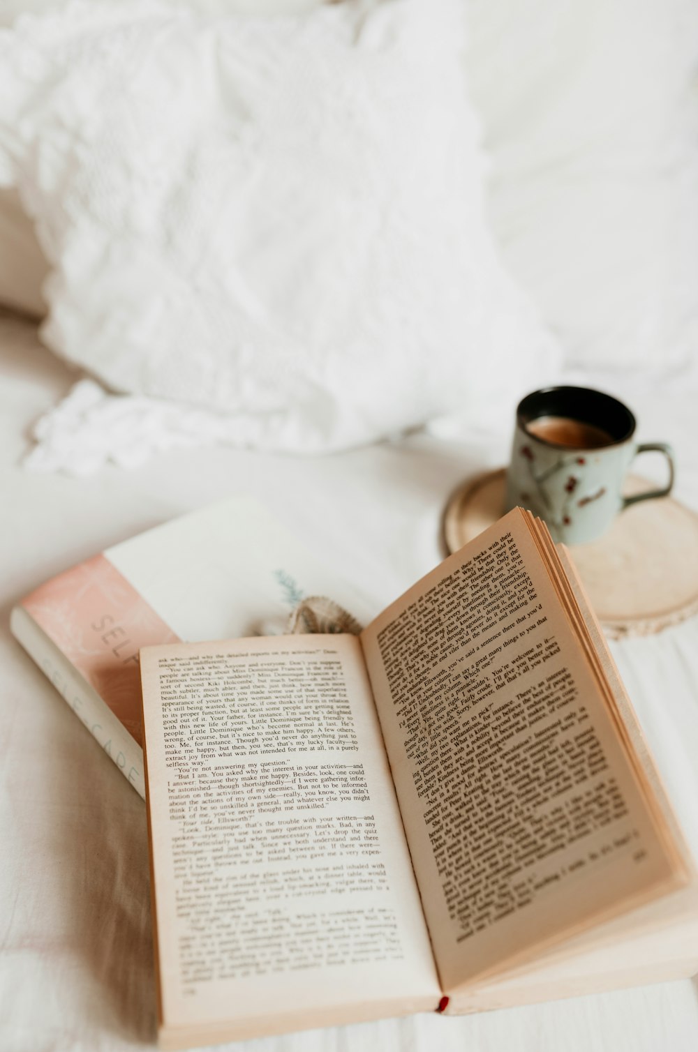 white book page beside white ceramic mug