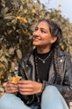 woman in black leather jacket smiling