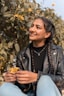woman in black leather jacket smiling