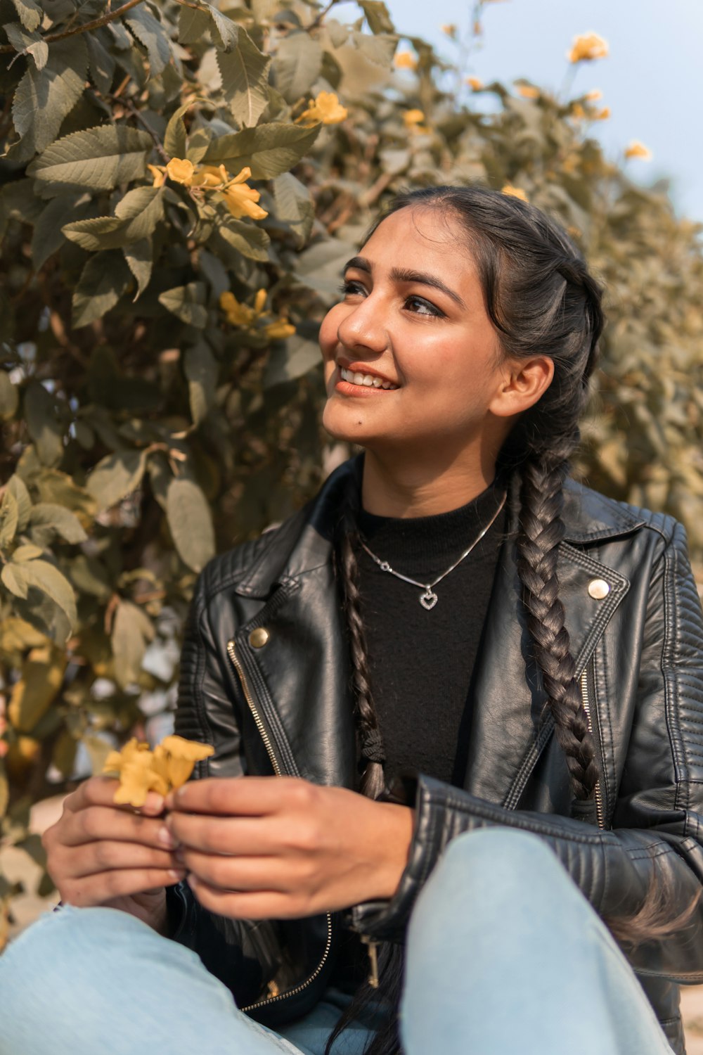 woman in black leather jacket smiling