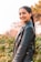 woman in black leather jacket smiling