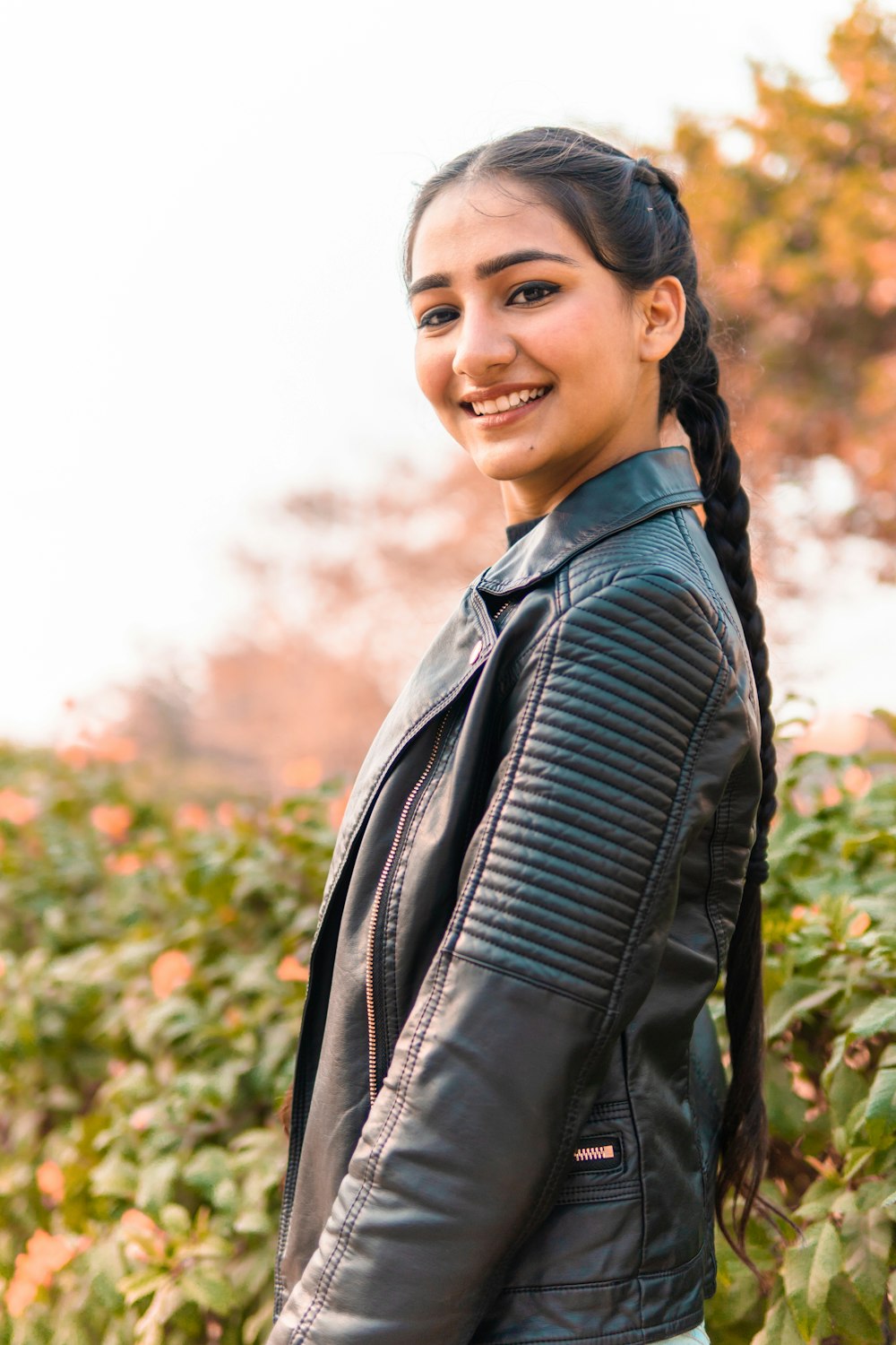 woman in black leather jacket smiling