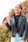 woman in black leather jacket standing near green plants during daytime