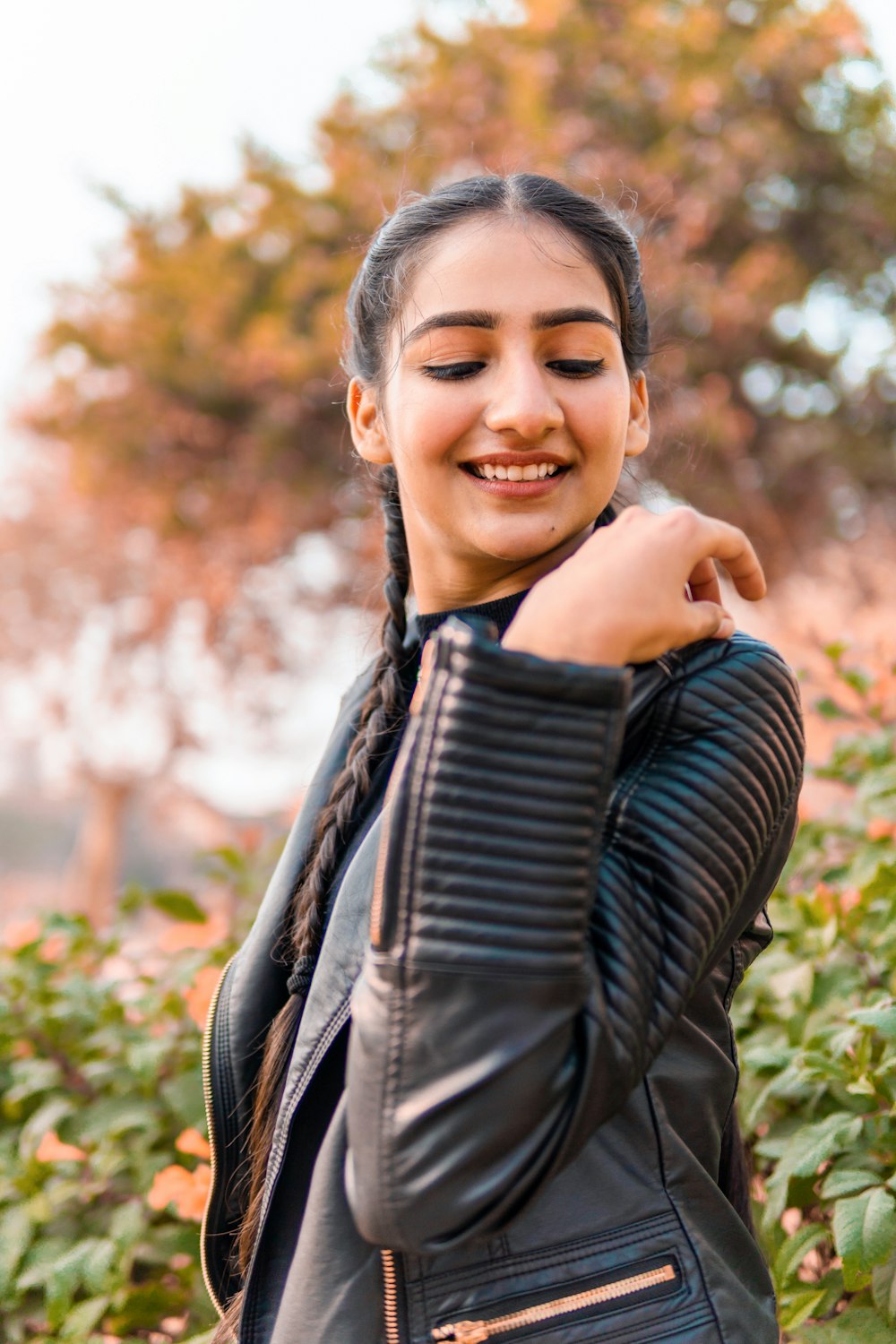 woman in black leather jacket smiling