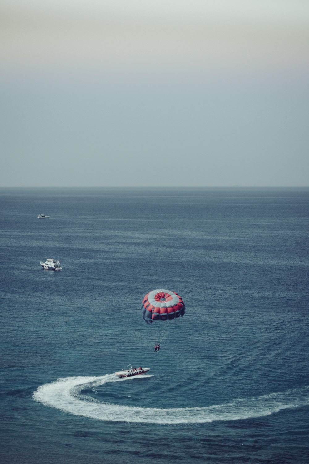 red and white polka dot umbrella on sea during daytime