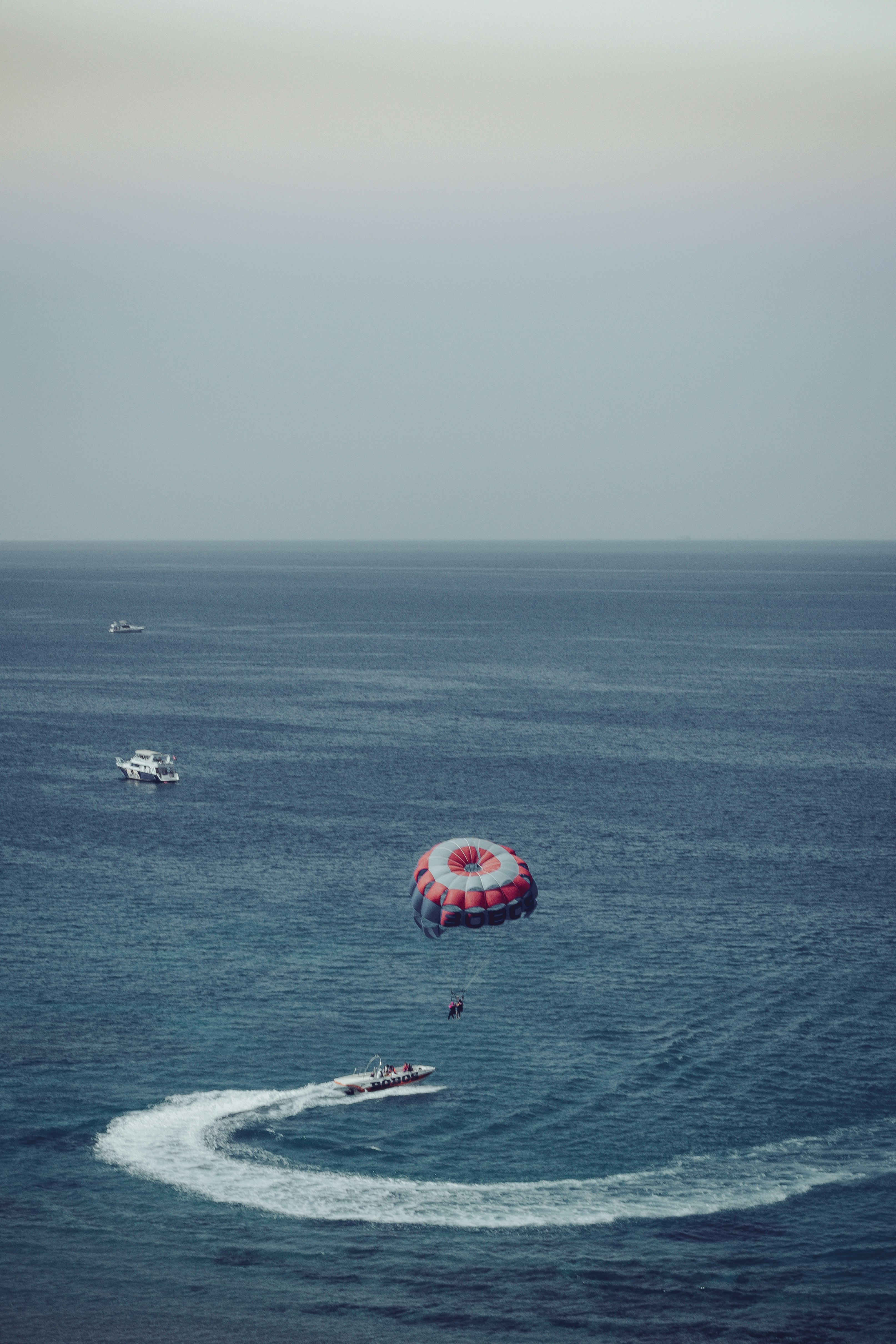 red and white polka dot umbrella on sea during daytime