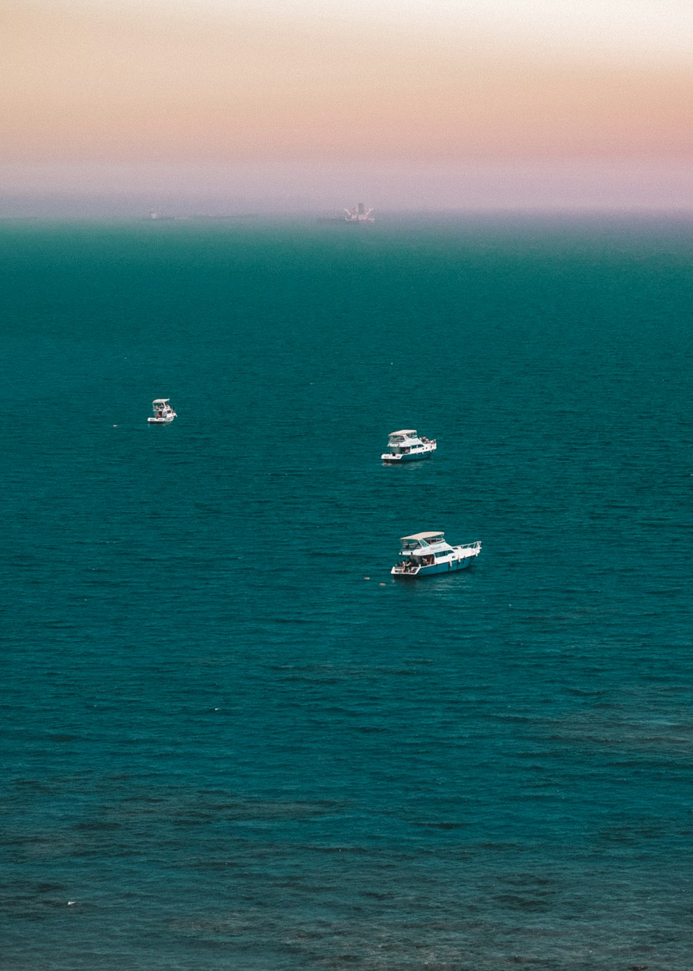 white and black boat on sea during daytime