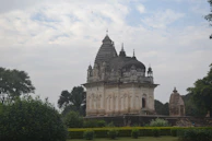 The Shiva temple built under Shri Sumitacharya Ji Maharaj's guidance surrounded by lush greenery.