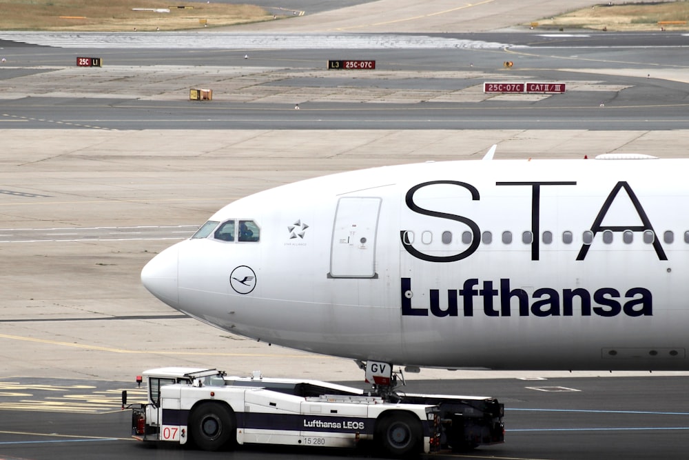 white passenger plane on airport during daytime