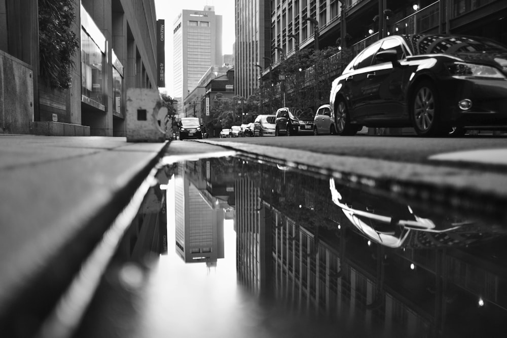 grayscale photo of cars on road