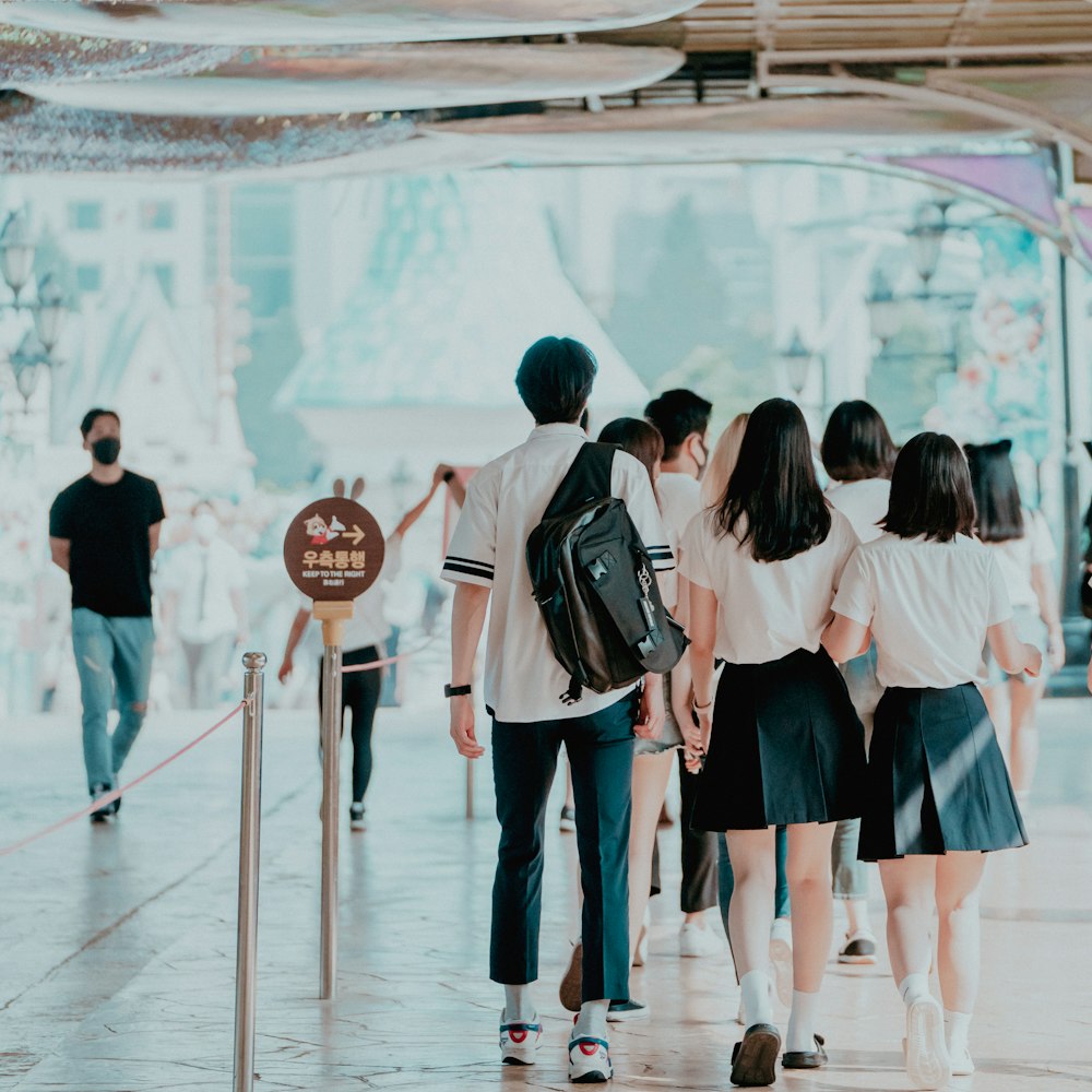 group of people standing on white floor tiles