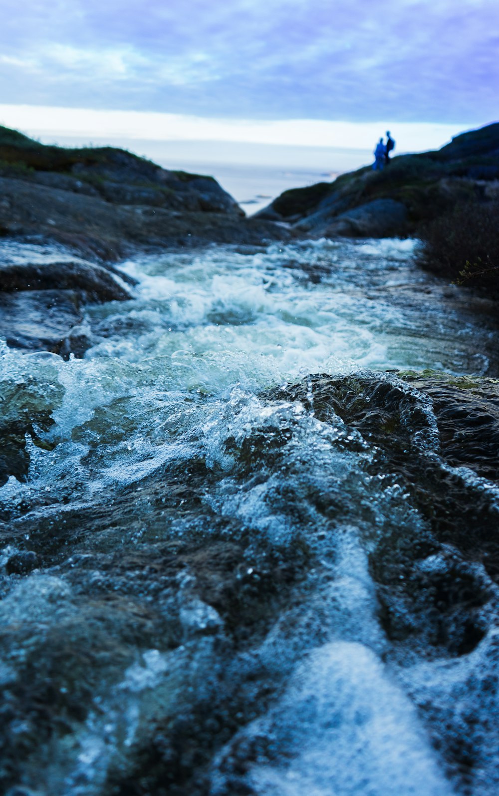 water waves hitting rocks during daytime