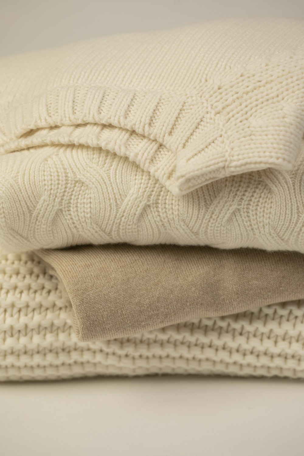 white textile on white textile