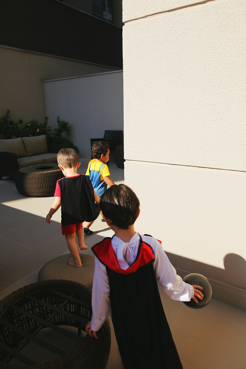 boy in blue and red polo shirt standing beside boy in white long sleeve shirt