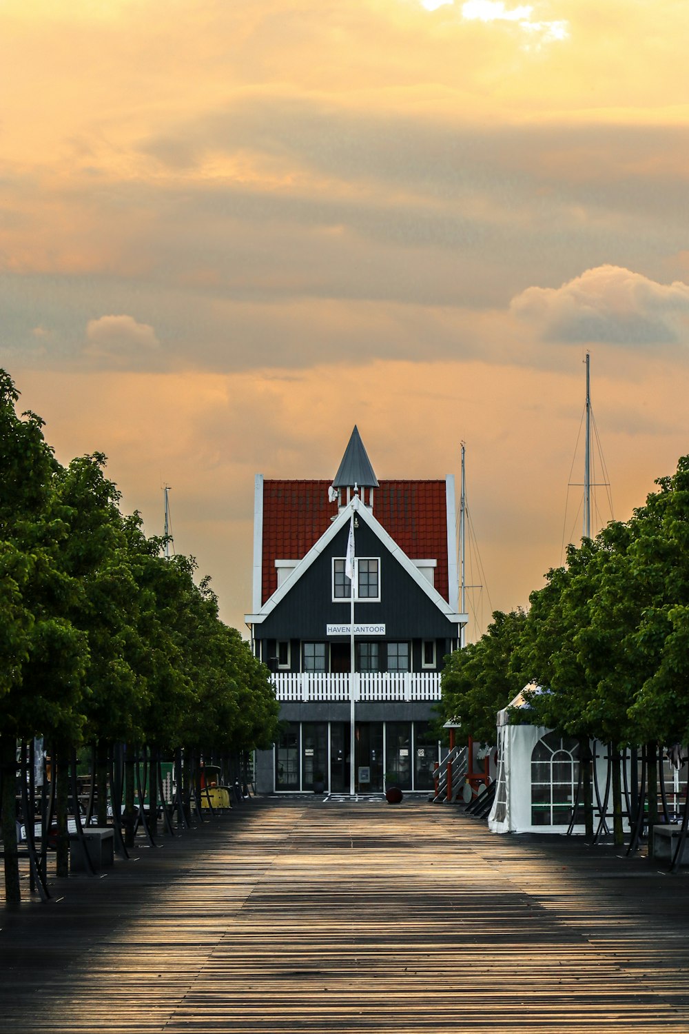 black and white house surrounded by green trees during daytime