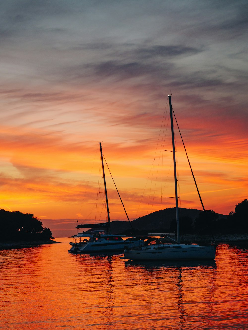 silhouette of boat on water during sunset